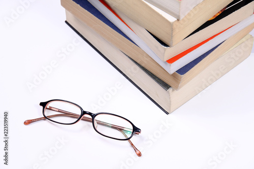 Glasses with pile of books