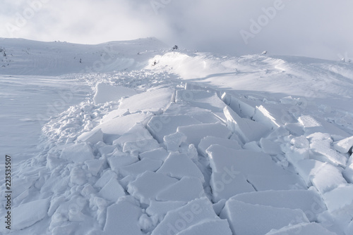 Snow avalanche in winter mountains. Danger extreme concept