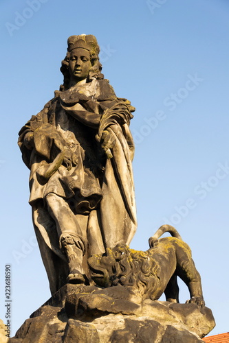 Statue of Saint Vitus from Ferdinand Maxmilian Brokoff 1714 on Charles Bridge near Mala Strana Bridge Tower, Prague, Czech Republic, sunny day, clear blue sky background