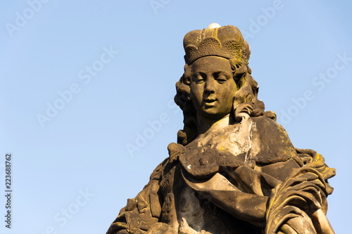 Statue of Saint Vitus from Ferdinand Maxmilian Brokoff 1714 on Charles Bridge near Mala Strana Bridge Tower, Prague, Czech Republic, sunny day, clear blue sky background