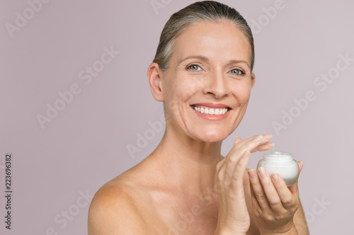  Woman holding jar of moisturizer