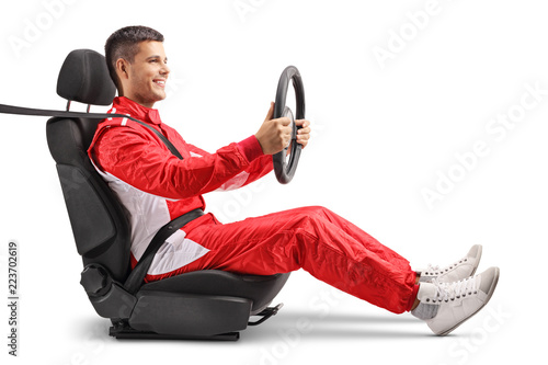 Racer sitting in a car wheel and holding a steering wheel