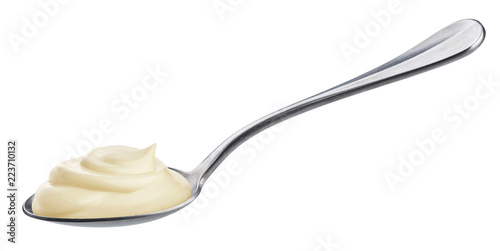Sour cream in spoon isolated on white background