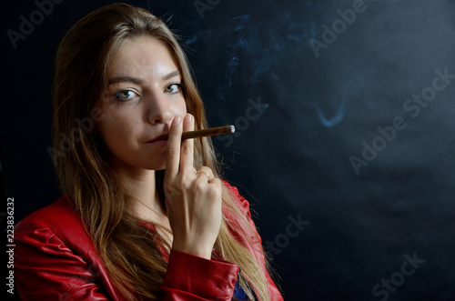 Young female smoking cigarillo