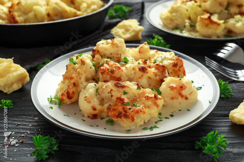 Roasted cauliflower with cheddar cheese sauce and herbs.