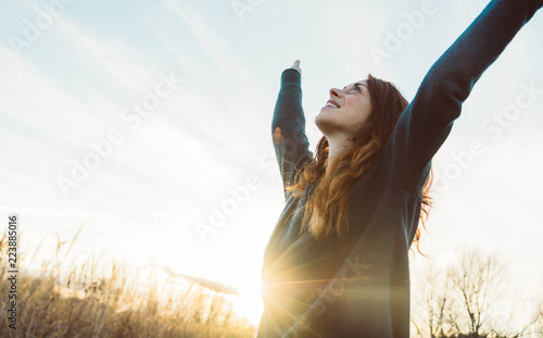 Young woman relaxing in summer sunset sky outdoor. People freedom style.