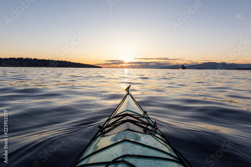 Sea Kayaking during a vibrant sunny summer sunset. Taken in Vancouver, BC, Canada.