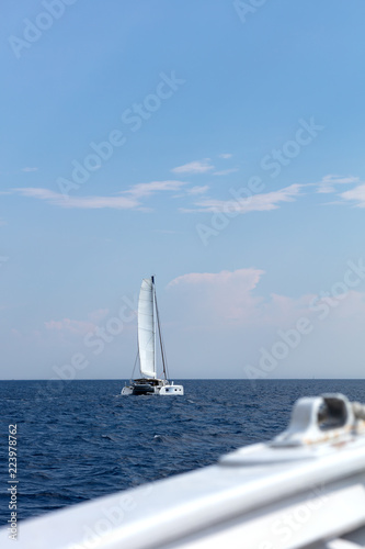 white catamaran sailing