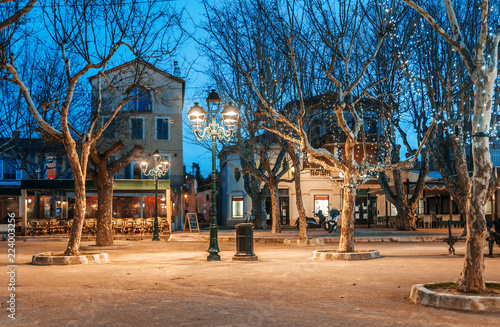 Beautiful night cityscape, tree illumination, lights and benches, central square Saint-Tropez, Provence, France