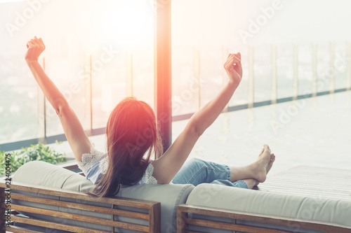 Easy relax business woman lifestyle after work at hotel sitting hands behind head for happy businesswomen people. Simplify Your Life Week. International happiness day.