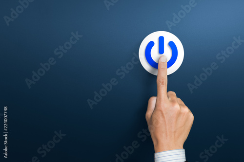 Hand of the businessman pressing power button. Start up business concept