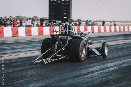 Dragster sets off on the racetrack. Dragster on the speedway. Drag wheel, torque, power, engine power.