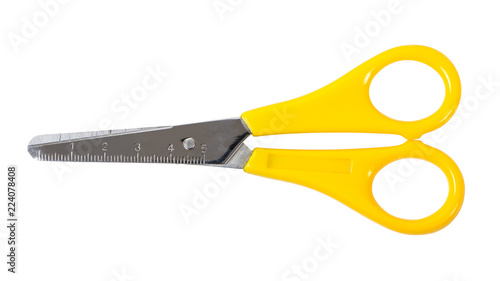 Yellow scissors with ruler isolated on white background