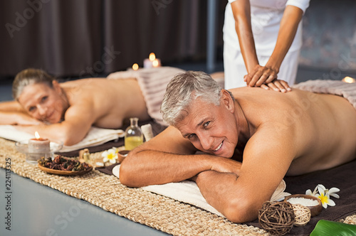Mature couple in spa getting massage