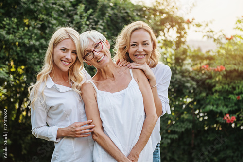 Three women enjoying outdoors, talking and laughing 