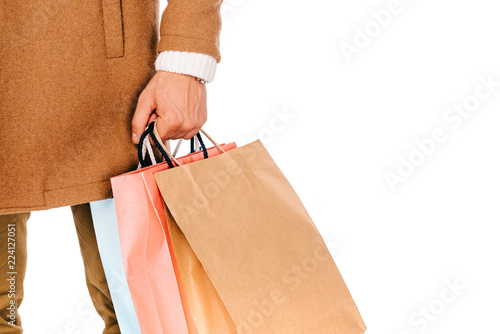cropped shot of man holding shopping bags isolated on white