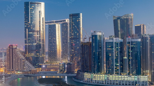 Buildings on Al Reem island in Abu Dhabi day to night timelapse from above.