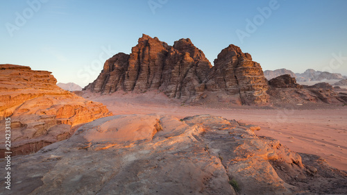 orange rocks in sunset in desert under blue sky
