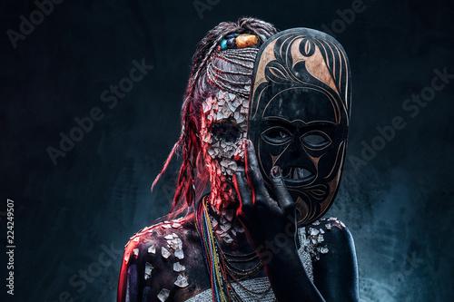 Close-up portrait of an African shaman female from the indigenous African tribe, wearing traditional costume. Make-up concept.