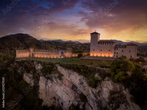 Medieval castle in Angera Italy with dramatic purple, red, yellow sky