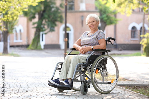 Senior woman in wheelchair outdoors