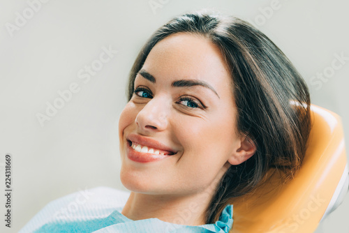 Beautiful female patient sitting in dentist chair