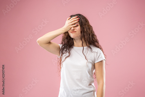 Why is that. Beautiful female half-length portrait isolated on trendy pink studio backgroud. Young emotional frustrated and bewildered woman. Human emotions, facial expression concept.