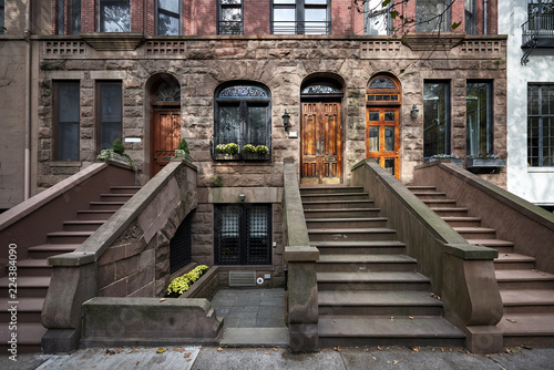 a row of colorful brownstone buildings in an iconic neighborhood of Manhattan New York