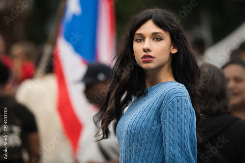 Beautiful activist woman protesting on city street rally