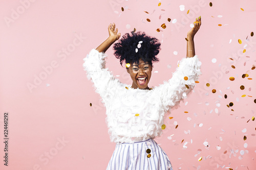 Fun party girl, smiling woman throwing confetti