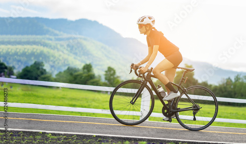 Cycling competition,cyclist athletes riding a race at high speed on road way, Sports women bikes in the morning,vintage color,selective focus, sports concept,low angle view,Business competition