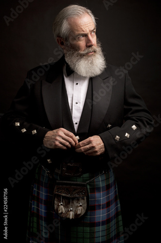 mature male model wearing kilt with grey hairstyle and beard
