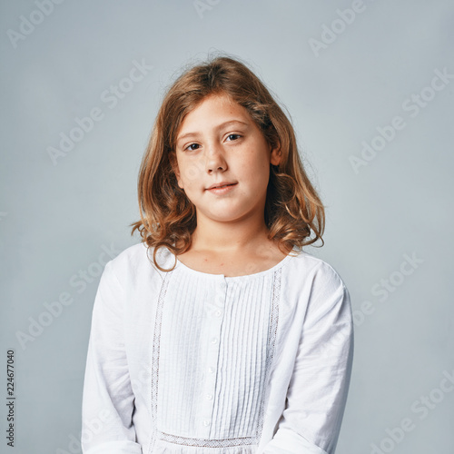 a studio portrait of a happy young girl