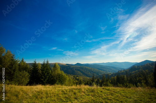Beautiful landscape of summer mountains with blue sky. Autumn mountain village panoramic landscape