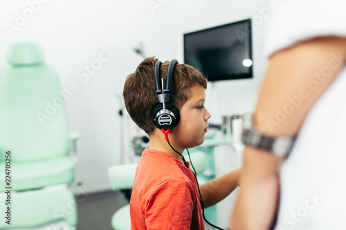 Young boy at medical examination or checkup in otolaryngologist's office