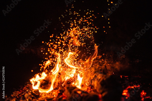 Fiery fire isolated on black isolated background . Beautiful yellow, orange and red fire flame texture style.