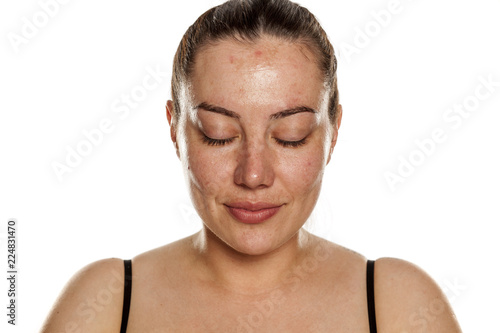 beautiful middle-aged woman without makeup on white background with closed eyes