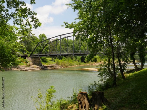 Old wooden bridge with steel railings at the War Eagle River in Rogers, Arkansas 