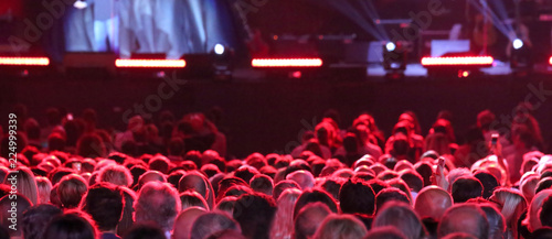 heads of people during live outdoor concert with many lights on