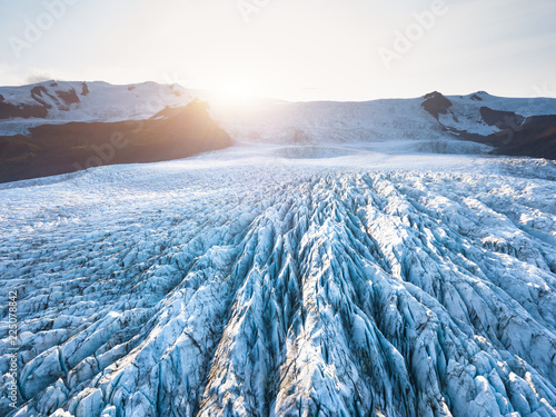 Glacier surface details viewed from above with crevasses and seracs, drone aerial view of Vatnajökull in Iceland, largest icelandic ice cap, beautiful patterns, summer sun