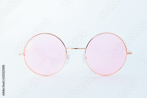 Round Italian sunglasses on white background. Pink eyeglasses. Front view of glasses with rounded retro frames