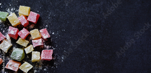 Colorful Traditional Turkish Delight on black background with a copy space on right