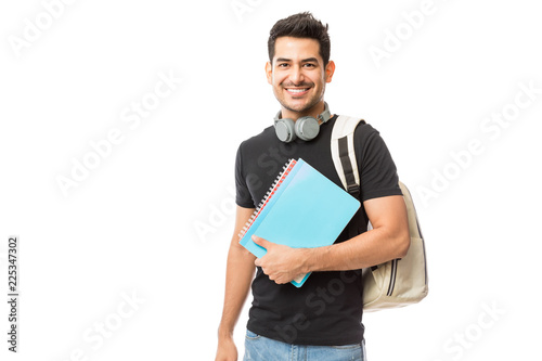 Smiling Young College Student With Books And Backpack