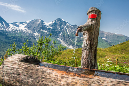 water tap in a wooden stump in grossglockner austria