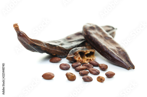 Carob on white background. Organic carob pods with seeds