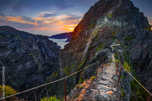 Madeira, Portugal. Hiking path between Pico do Arieiro and Pico do Ruivo at sunset above the clouds