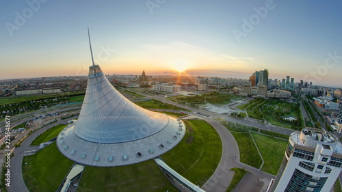 Elevated view with sunrise over the city center with Khan Shatyr and central business district Timelapse, Kazakhstan, Astana