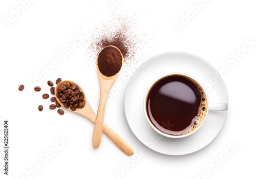 Coffee beans and ground coffee on wooden spoon with cup of black coffee