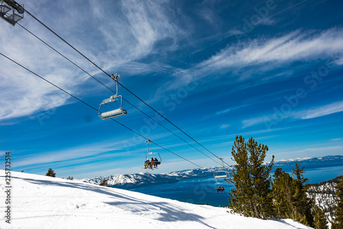Lake Tahoe from Heavenly Resort - skiing - looking at ski lift with lake in background - space for text top right