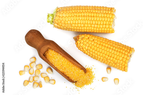 corn groats or cornmeal in wooden scoop and corncob isolated on white background. Top view. Flat lay